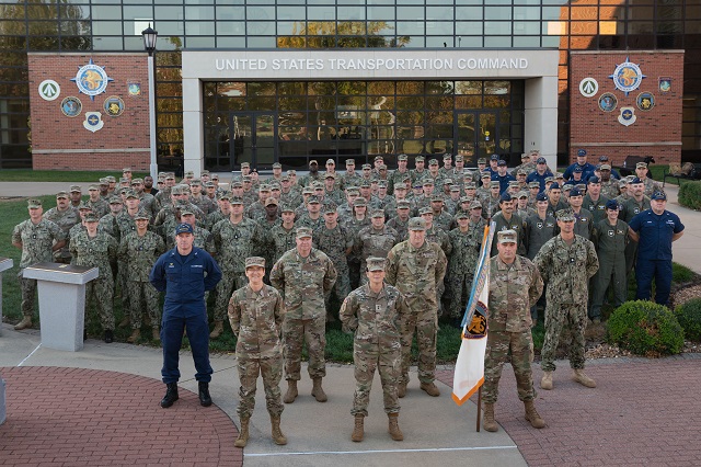Air Force Gen. Jacqueline Van Ovost, front left, commander of U.S. Transportation Command, and Army Maj. Gen. Cheryn Fasano, front center, 11th and final Joint Transportation Reserve Unit commander and now mobilization assistant to Van Ovost, poses with members of the JTRU prior to the unit’s deactivation. (U.S. Transportation Command photo by Mass Communication Specialist Seaman Allison Paris)
